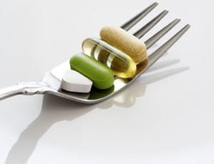 A shot of vitamin and medicines on a fork